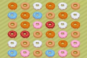 Rreshta donutsësh me ngjyra dhe zbukurime të ndryshme në një sfond jeshil