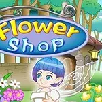 Një tabelë me mbishkrimin Flower Shop dhe një figurë fëmije krah një kopështi me lule shumëngjyrëshe