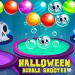 Topa me ngjyra dhe kafkë skeleti me sfond blu dhe tekst Halloween Bubble Shooter
