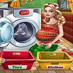 Një grua shtatzënë qëndron pranë një makine larëse të hapur me një kosh për lodra dhe një kosh për rroba përpara