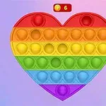 Një lodër pop-it në formë zemre me ngjyra ylberi në sfond pastel