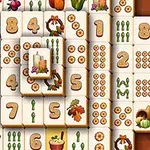 Dërrasa të bardha me simbole të ndryshme si numra, fruta, perime dhe dekorime festive janë vendosur në një formacion grumbulluar