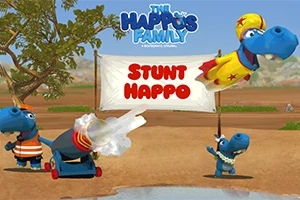 Tre karaktere blu në një peizazh natyror me një tabelë pranë tyre ku shkruhet Stunt Happo, njëri është duke u hedhur nga një top