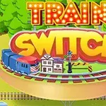 Një tren blu dhe një sinjal hekurudhor në një platformë rrethore, me fjalët Train Switch të shkruara mbi të, në sfondin e një peizazhi me pemë