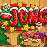 Një shenjë festive me mbishkrimin “X-JONG” e zbukuruar me yje, borë dhe flokë bore, me dhurata të mbështjella dhe një pemë të Krishtlindjeve në sfond